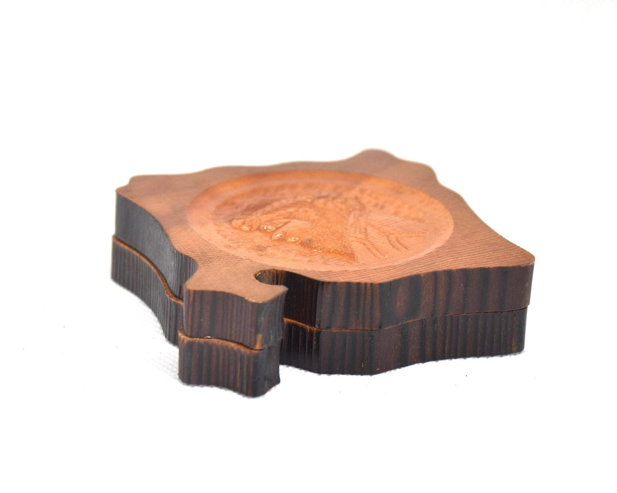 Ainu wooden coaster set stacked at a different angle showing layered profiles