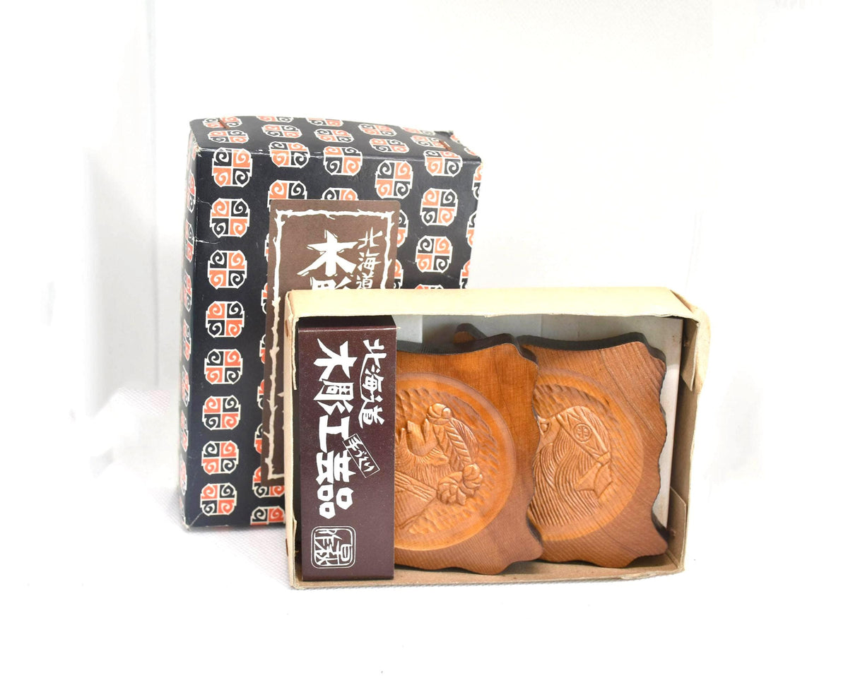 Ainu wooden coaster set showing open original packaging box and carved details