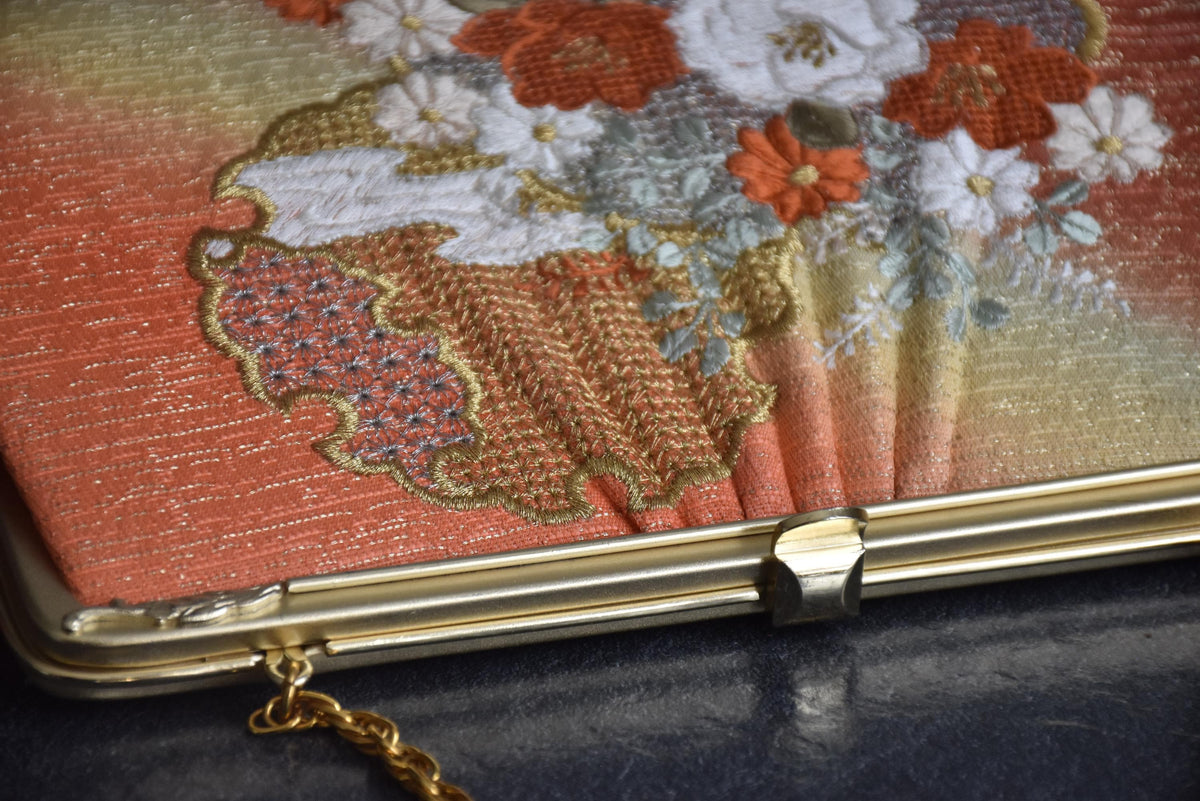 Floral Woven Kimono Clutch close-up of the ornate metal frame and kiss-lock clasp