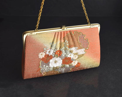 Floral Woven Kimono Clutch shown from the front with floral embroidery and gold frame