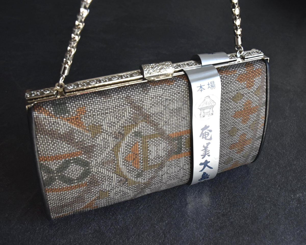 Amami Oshima Tsumugi silk clutch front view with paper label attached