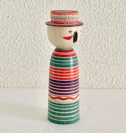 Sadayoshi Hoshi kokeshi doll viewed from the right side showing facial features and painted hair