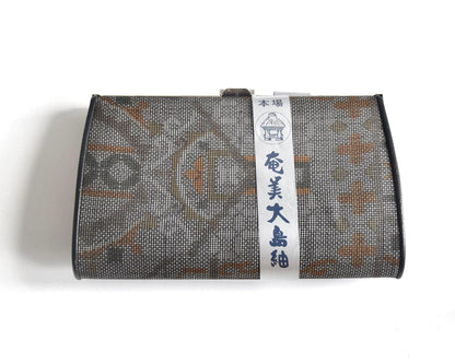 Amami Oshima Tsumugi silk clutch front design with intricate pattern detail