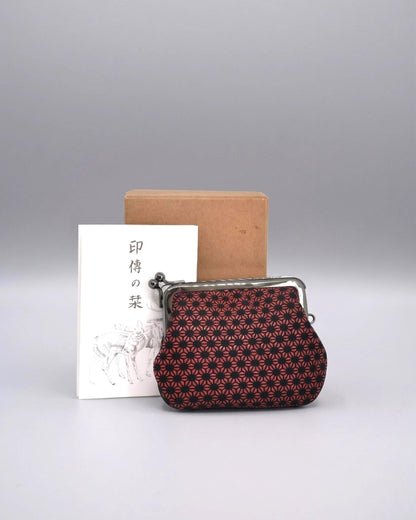 Inden Deerskin Coin Purse With Lacquer Pattern in front of its original box and informational leaflet