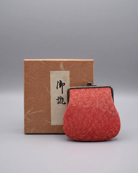 Red Silk Kimono Textile Clasp Coin Purse placed in front of its matching gift box with a traditional paper label