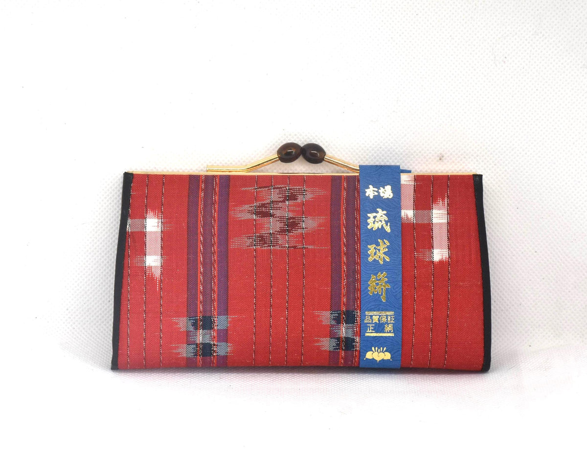 Ryukyu Kasuri Geometric Ikat Silk Wallet Red front view showing the label band and clasp