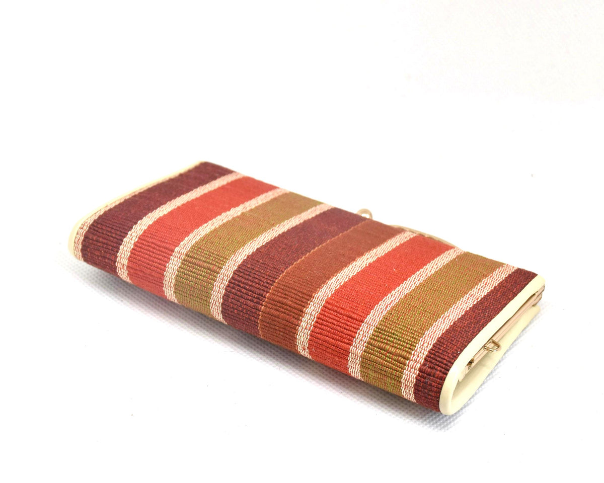 Yaeyama Minsa-Ori coin purse side view showing the structured profile and striped textile
