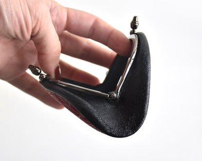 Inden deerskin coin purse top view showing the open metal frame and curved edge structure