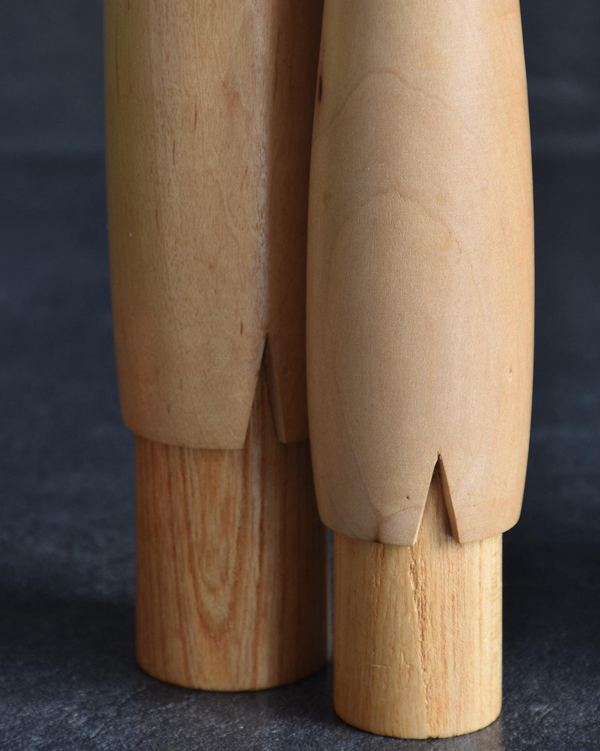 Shido Shozan kokeshi pair close-up of the lower base cuts