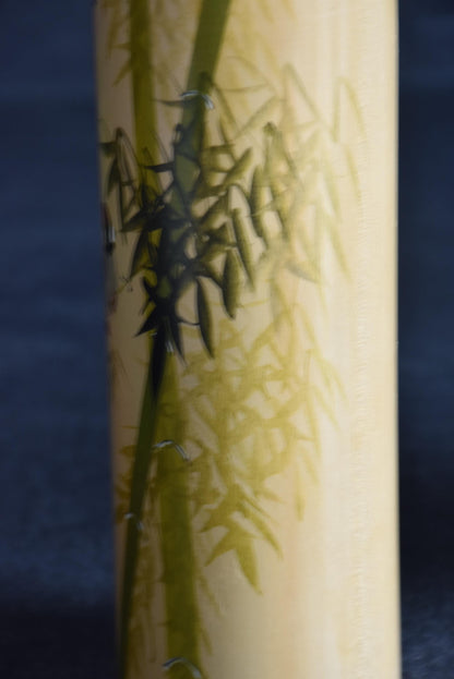 Pair of Japanese kokeshi dolls bamboo and floral motif showing hand-painted green bamboo stalks