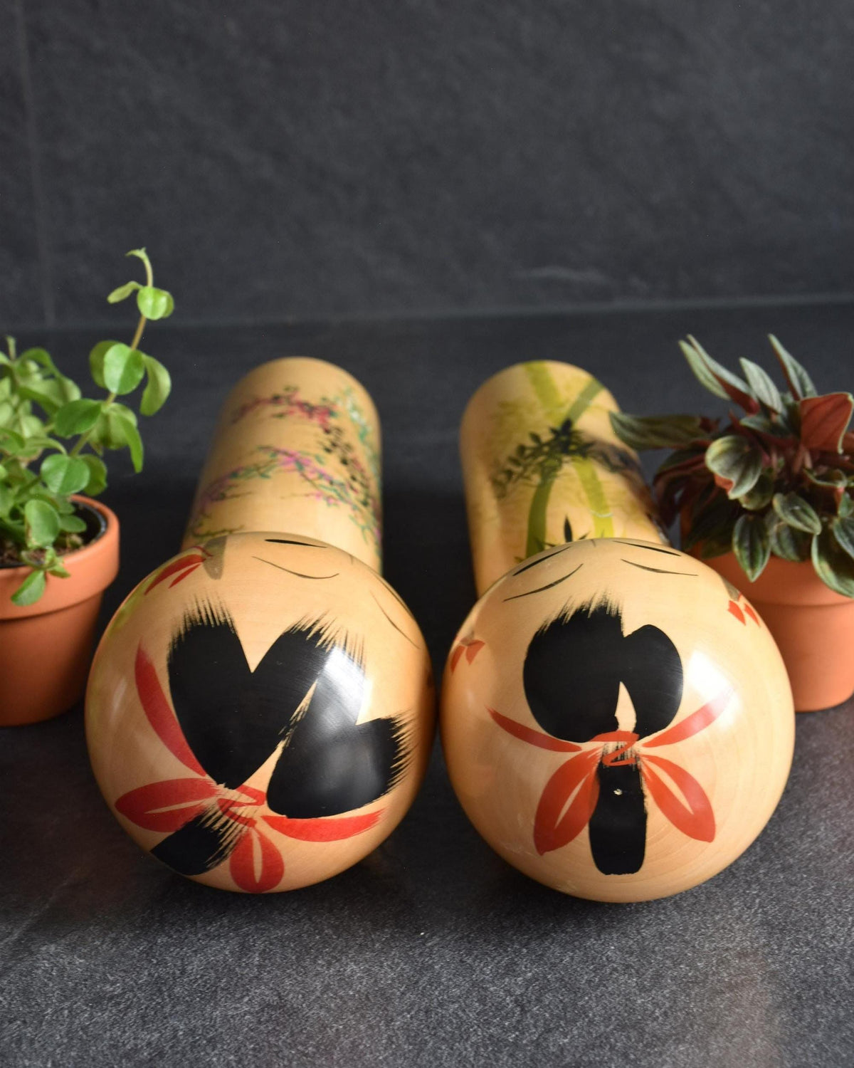 Pair of Japanese kokeshi dolls bamboo and floral motif back view of heads