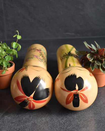Pair of Japanese kokeshi dolls bamboo and floral motif back view of heads