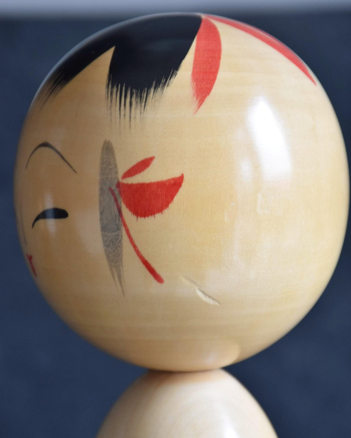 Pair of Japanese kokeshi dolls bamboo and floral motif head side view