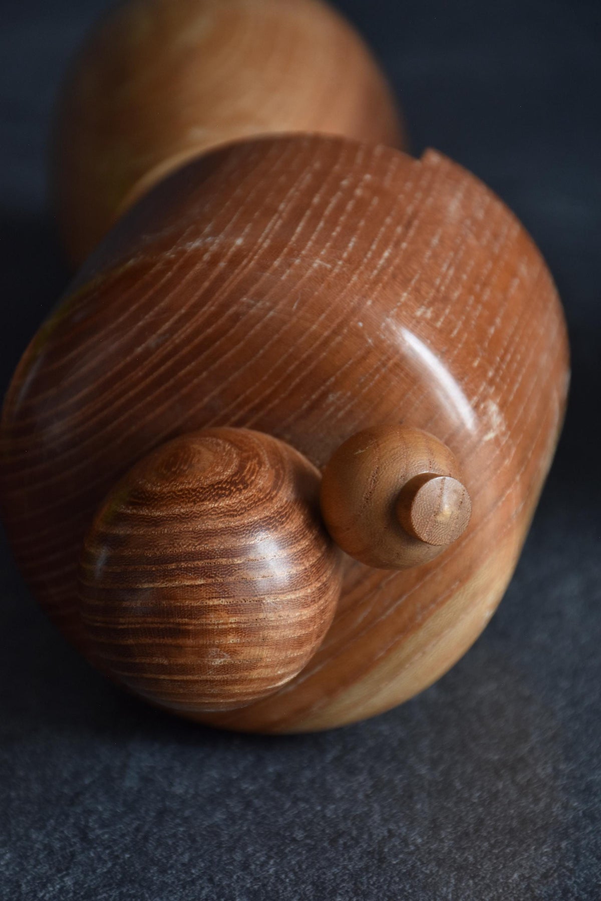 Masuo Sato kokeshi doll top view showing the rounded hair bun and hairpin detail