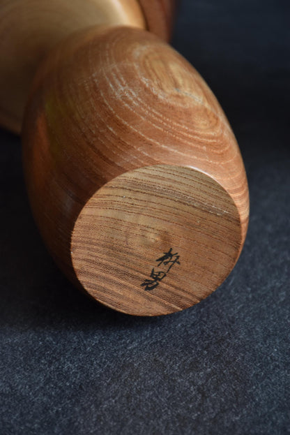 Masuo Sato kokeshi doll base with artist signature stamped on the bottom wood
