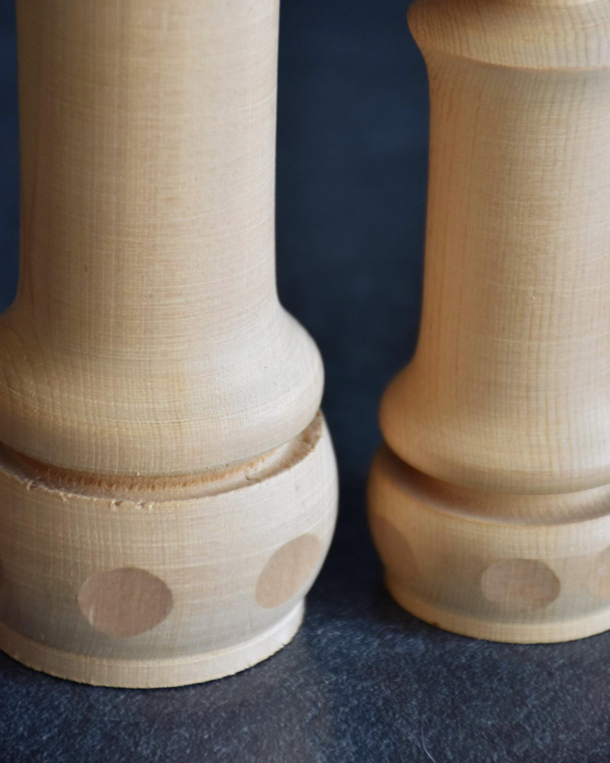 Isamu Ise kokeshi dolls pattern detail showing stamped accents on lower rims.