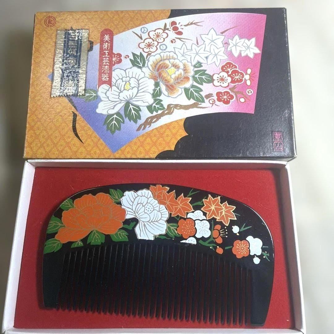 Japanese Black Lacquer Kushi Comb displayed alongside its original paper presentation box
