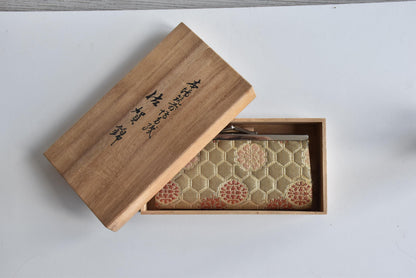 Hakata-Ori Saga Nishiki Geometric Silk Clasp Purse resting inside its original tomobako wooden box