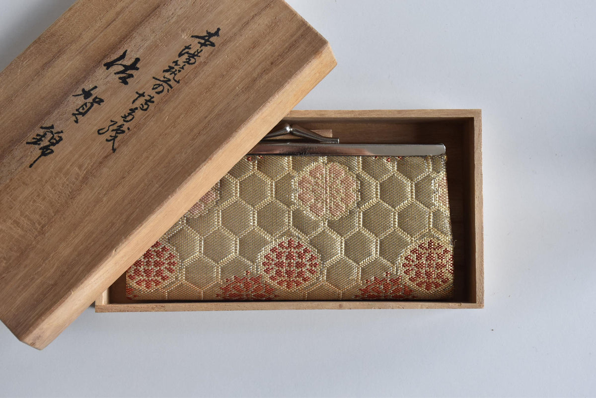 Hakata-Ori Saga Nishiki Geometric Silk Clasp Purse angled view inside the tomobako wooden gift box
