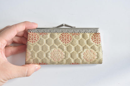 Hakata-Ori Saga Nishiki Geometric Silk Clasp Purse held in hand showing size perspective