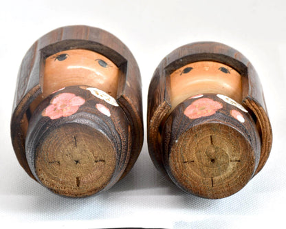 Sosaku Kokeshi Pair showing the wooden bases with circular grain marks