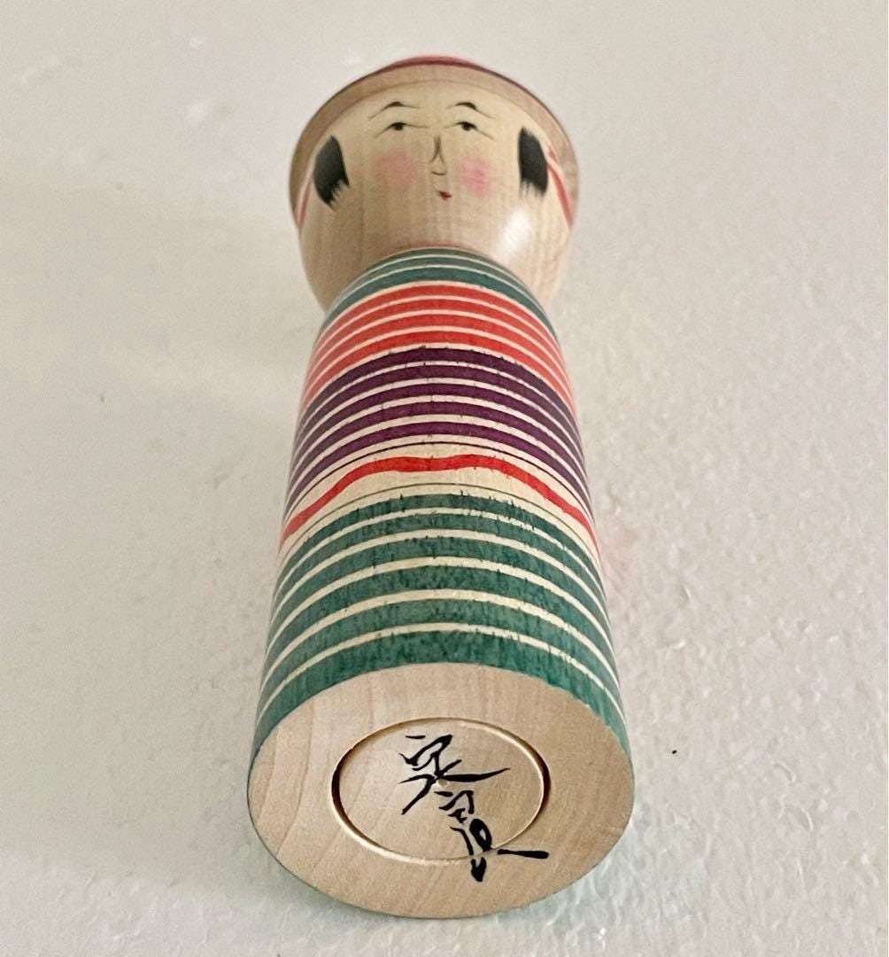 Sadayoshi Hoshi kokeshi doll base showing the artist signature hand-painted on the wood