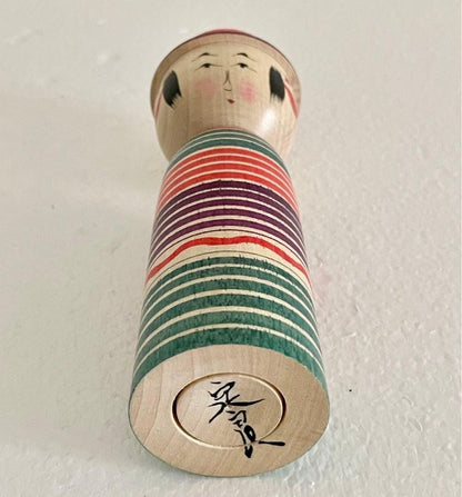 Sadayoshi Hoshi kokeshi doll base showing the artist signature hand-painted on the wood