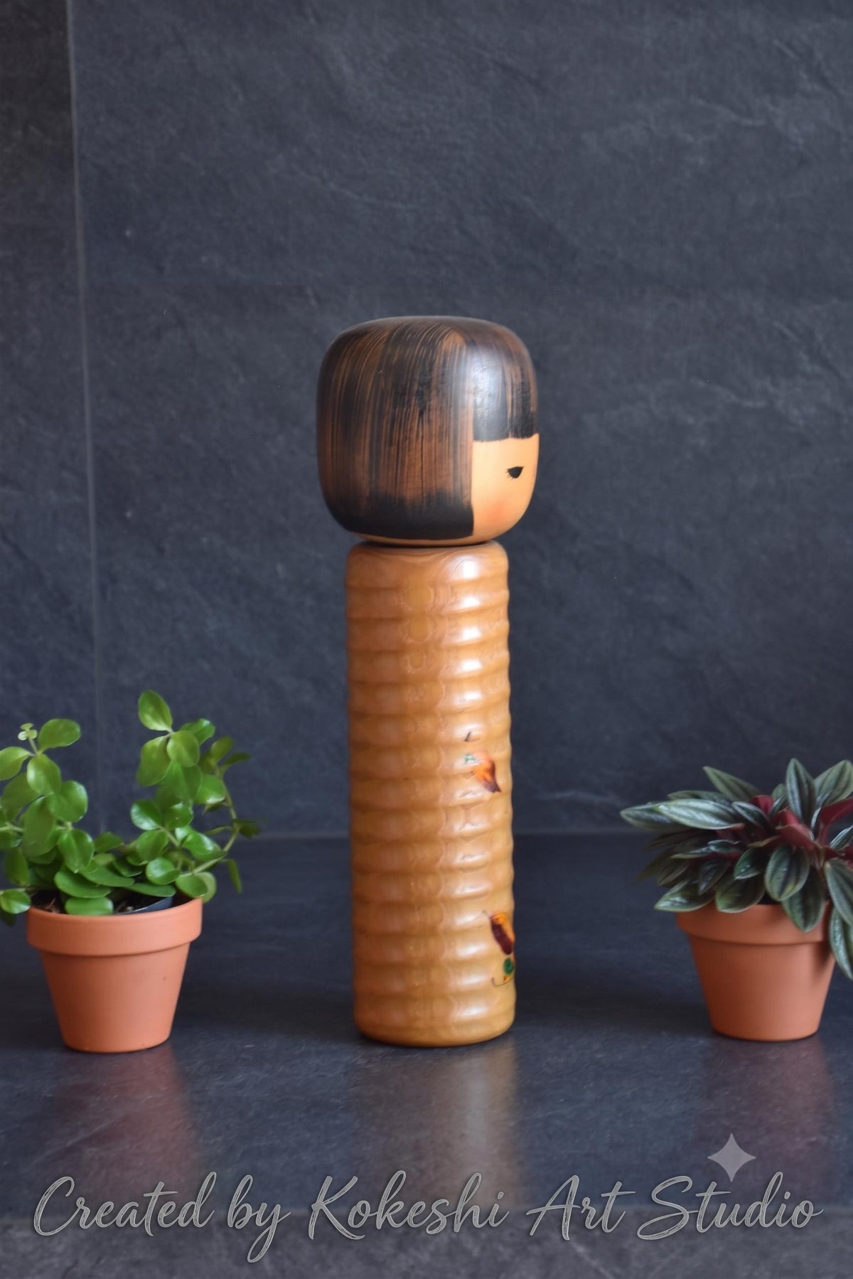 Usaburo sosaku kokeshi doll side profile showing carved and painted body