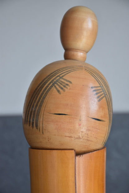 Sato Suigai Kiku No Omoi kokeshi doll head with smooth black bun and closed eyes
