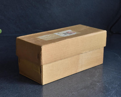 Sosaku Kokeshi Shijo by Sato Suigai shown inside its original labeled storage box