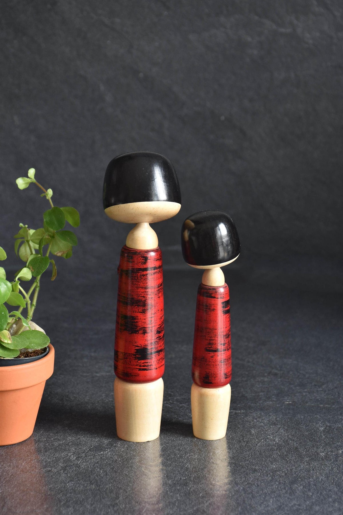 Aida Seihou kokeshi Sisters angled view focusing on the upper bodies and matching red bark finish kimonos