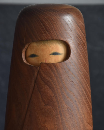 Miyajima Muhitsu Sosaku Kokeshi Yuki Michi Snowy Road close up of painted face peeking from mino cloak