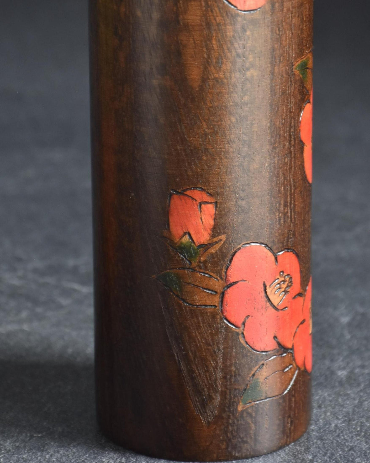 Ryozo Tsujita kokeshi doll body detail showing incised and hand-painted red camellia blossoms