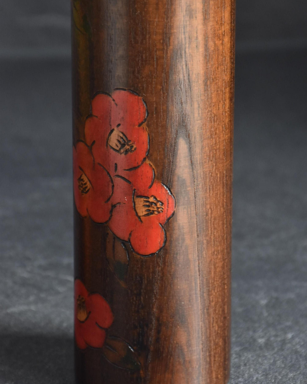 Ryozo Tsujita kokeshi doll close-up of the red camellia blossom decoration on the wooden body