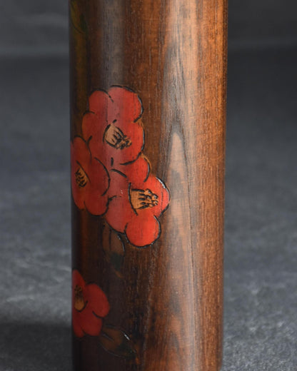Ryozo Tsujita kokeshi doll close-up of the red camellia blossom decoration on the wooden body