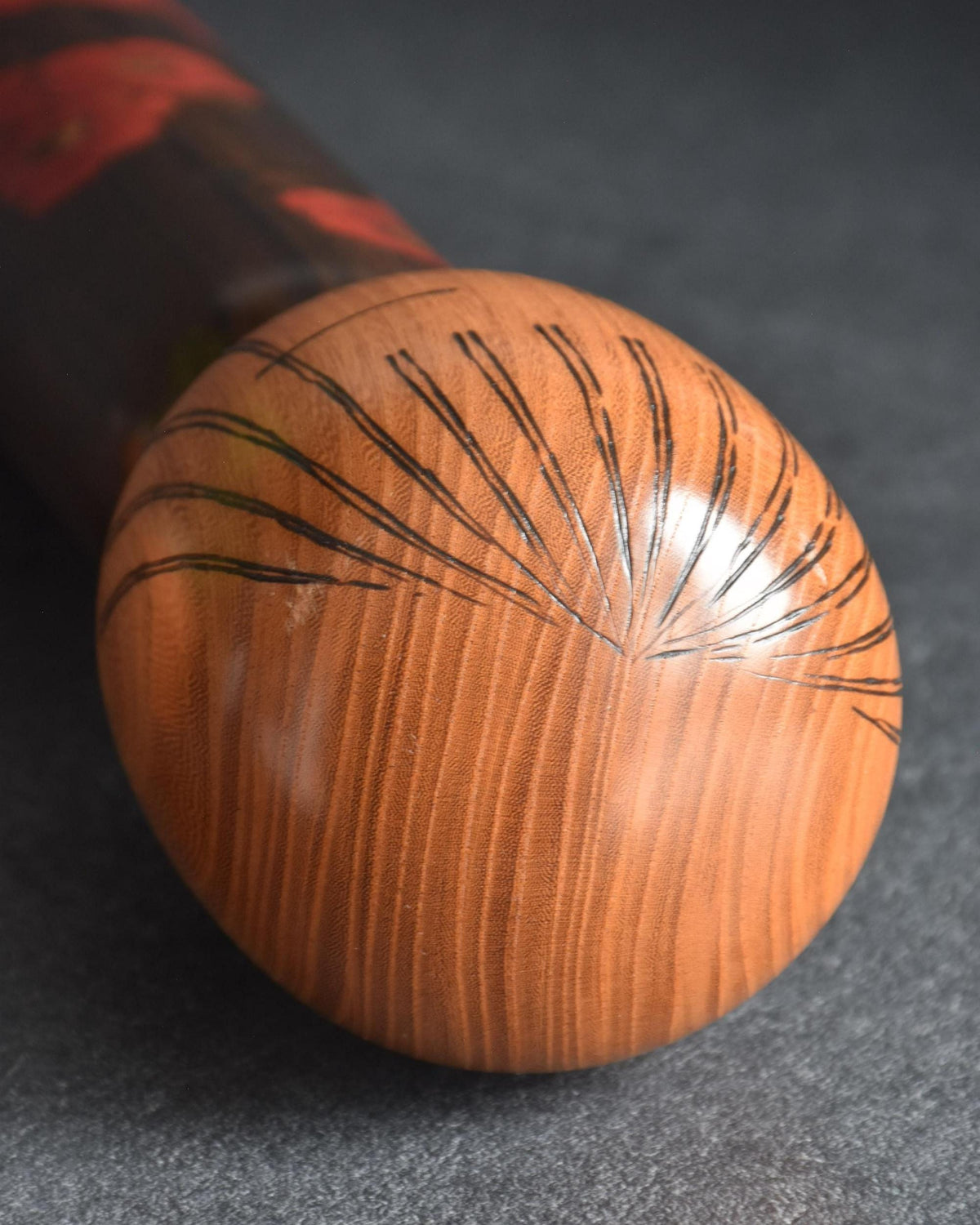 Ryozo Tsujita sosaku kokeshi doll showing a close up of the rounded head with delicate incised hair lines