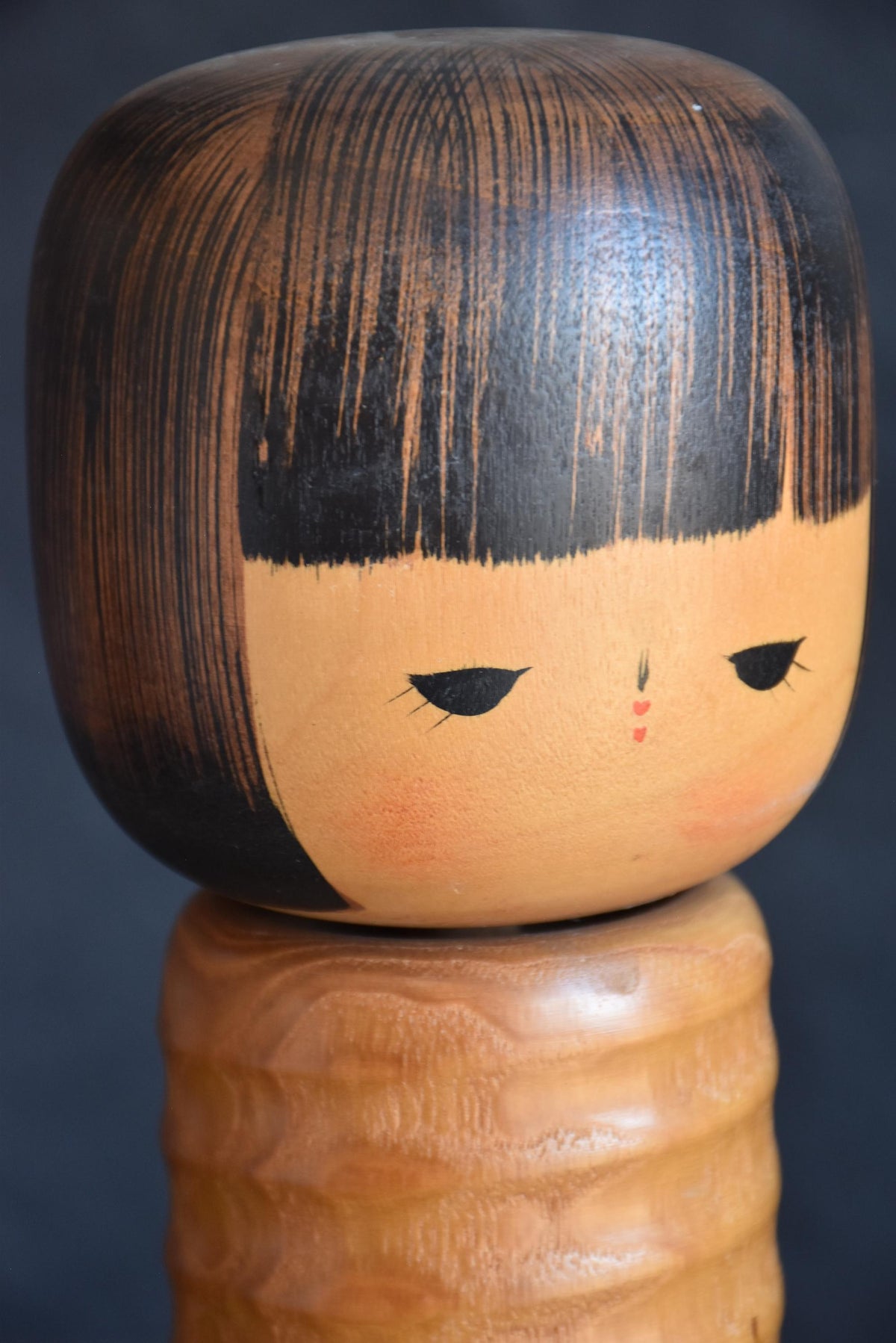 Usaburo sosaku kokeshi close up of facial expression with painted eyes