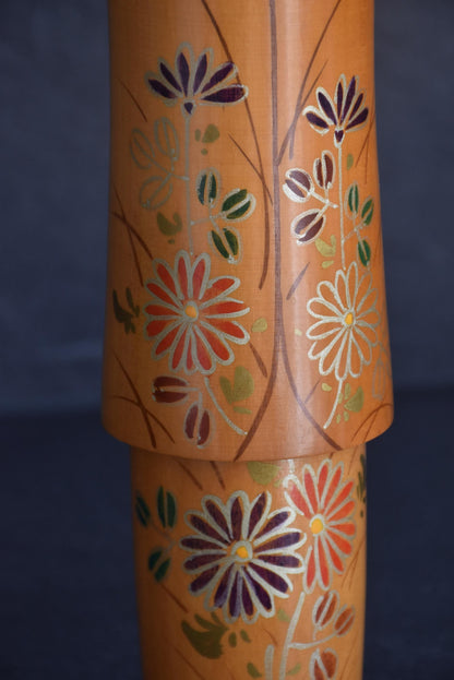Sato Suigai Kiku No Omoi kokeshi doll body featuring hand-painted colorful chrysanthemums