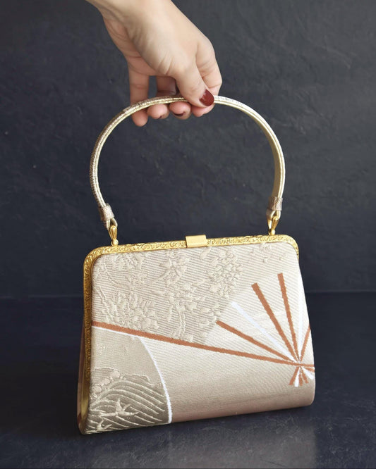 Gold And Champagne Obi Brocade Kimono Bag With Fan Motif held by hand