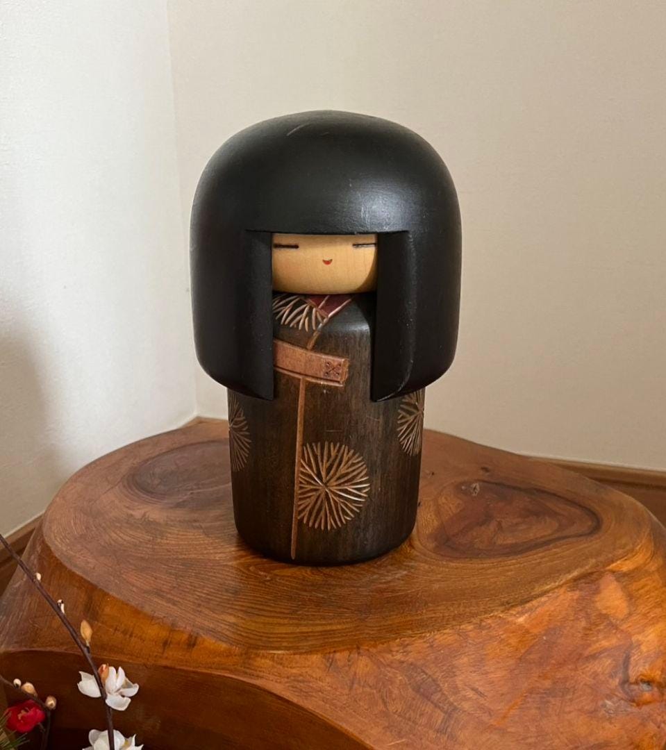 Sansaku Sekiguchi Sosaku Kokeshi Dojo handcrafted wooden doll with dark bobbed hair and carved floral kimono
