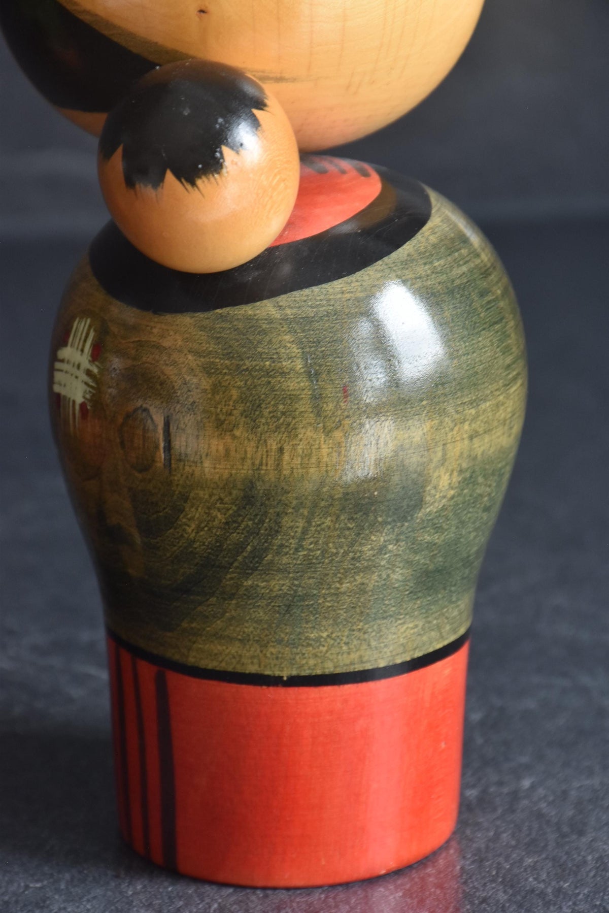 Hajime Miyashita kokeshi close up of child carried on back
