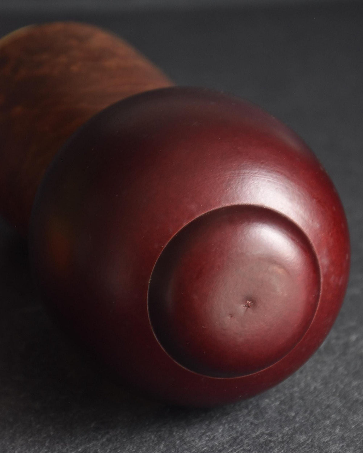 Sosaku Kokeshi Shijo by Sato Suigai showing the back of the deep burgundy sculpted hairstyle