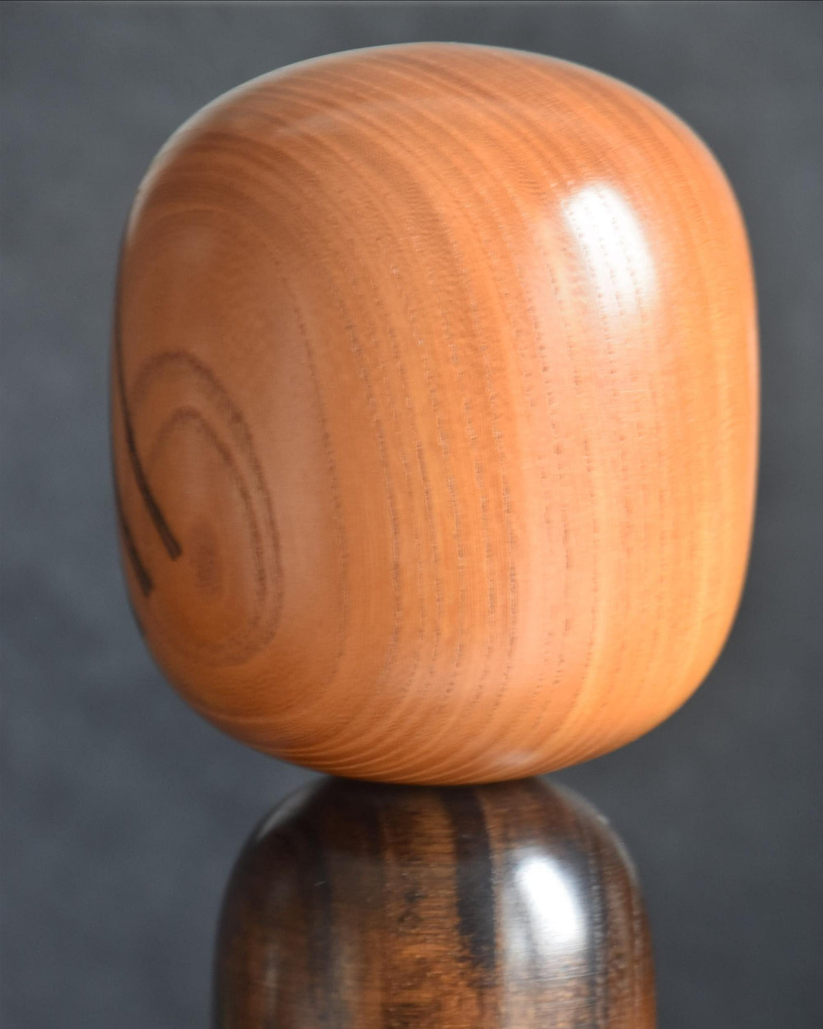 Ryozo Tsujita kokeshi doll side profile of the head showcasing the warm natural wood tone