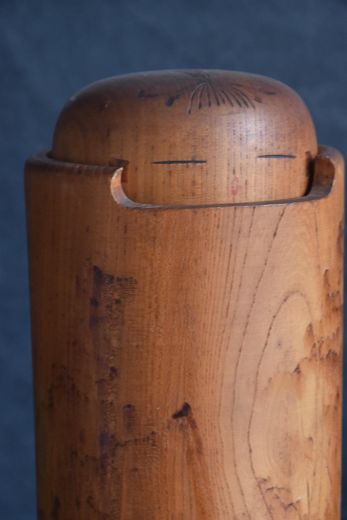 Miyajima Muhitsu kokeshi doll head detail showing pyrography hair and face