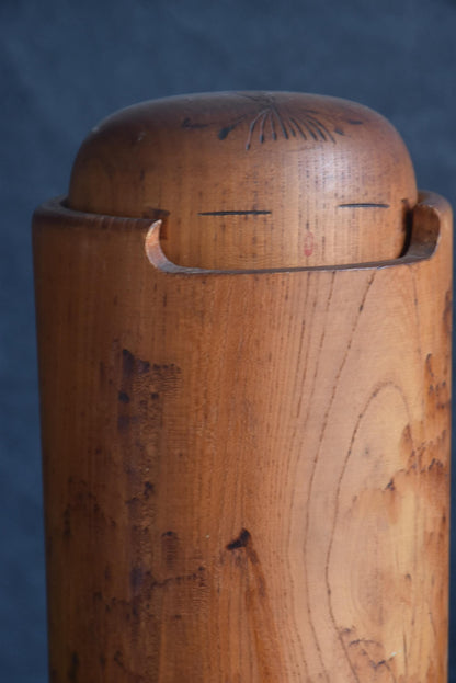 Miyajima Muhitsu kokeshi doll head detail showing pyrography hair and face