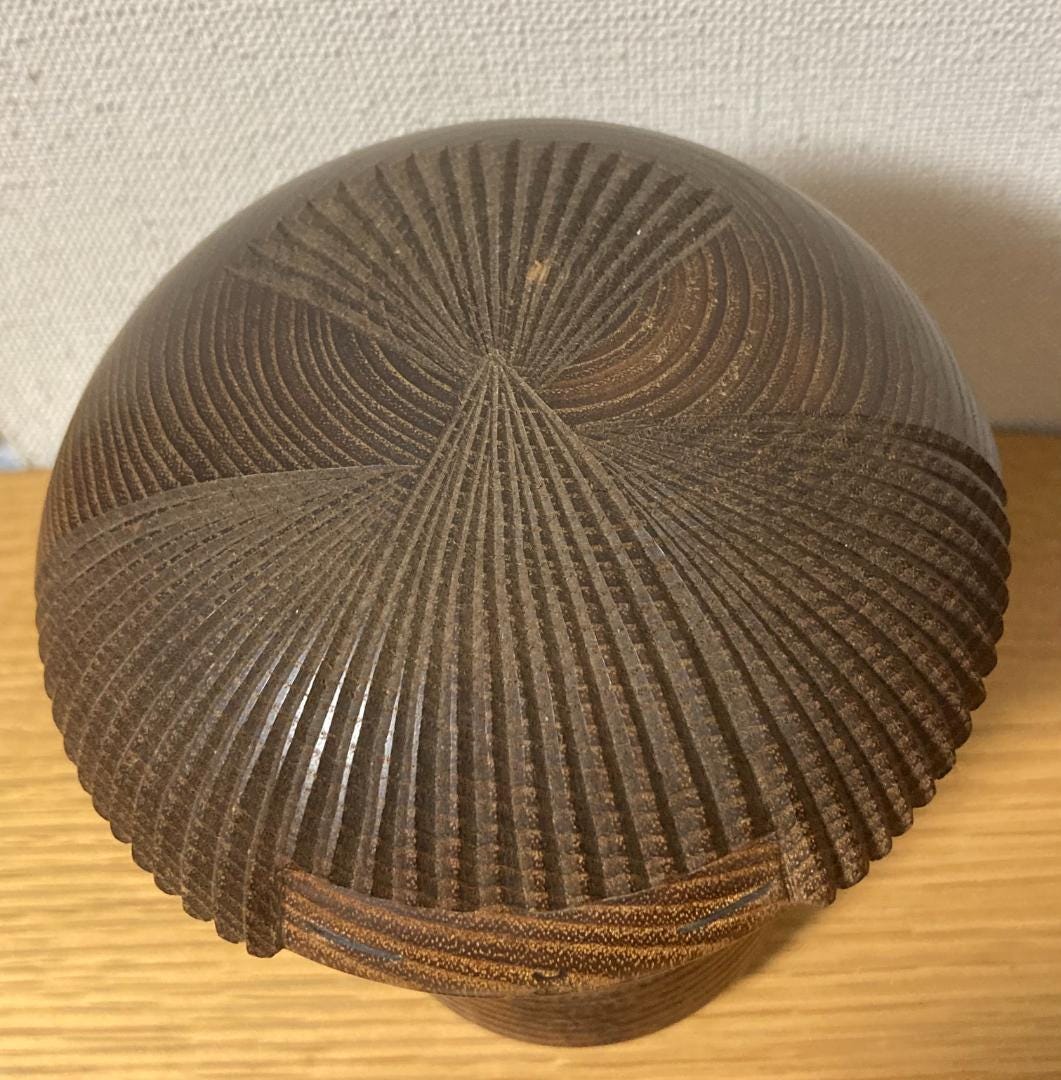 Kenichi Murakami kokeshi hair pattern detail showing intricate rhythmic wood carvings